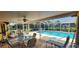 Covered patio with dining furniture, lounge chairs and overlooking the pool for relaxation and entertainment at 3357 Vassar St, Port Charlotte, FL 33980