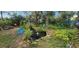 Backyard pond and water feature, complemented by lush plants, chairs, and a shed at 3357 Vassar St, Port Charlotte, FL 33980