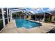 Sparkling pool with screened lanai and furniture perfect for outdoor relaxation at 3357 Vassar St, Port Charlotte, FL 33980