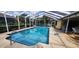 Sparkling pool with screened lanai, clear water, and dolphin decoration in the plaster at 3357 Vassar St, Port Charlotte, FL 33980