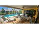 Relaxing screened-in pool area with ample seating, clear blue water, and lush landscaping at 3357 Vassar St, Port Charlotte, FL 33980