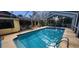 View of inground pool featuring screened-in enclosure, patio and serene landscaping at 3357 Vassar St, Port Charlotte, FL 33980