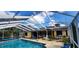 View of sparkling pool, screened in enclosure, and patio furniture for outdoor entertaining at 3357 Vassar St, Port Charlotte, FL 33980
