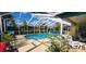 Relaxing screened-in pool area with ample seating, lush landscaping, and clear blue water at 3357 Vassar St, Port Charlotte, FL 33980