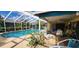 Screened-in pool area with lounge chairs, creating a private and refreshing outdoor retreat at 3357 Vassar St, Port Charlotte, FL 33980