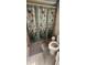 Bathroom shower with patterned shower curtain, toilet, and gray bathmat at 3357 Vassar St, Port Charlotte, FL 33980