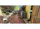 Exterior side yard with patio and brick, featuring plants, storage and the side of the house at 3357 Vassar St, Port Charlotte, FL 33980