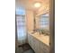 Bright bathroom featuring a modern vanity with a shower behind a decorative curtain at 354 Blackburn Blvd, North Port, FL 34287