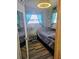 Compact bedroom featuring a comfortable bed, ambient lighting, and a mirror for added space and functionality at 354 Blackburn Blvd, North Port, FL 34287