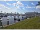 Picturesque waterfront view of a dock with boats and a clubhouse in the background at 354 Blackburn Blvd, North Port, FL 34287