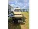 A view of the back of a golf cart in a grassy back yard setting at 354 Blackburn Blvd, North Port, FL 34287