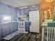 Efficient kitchen featuring appliances, light blue cabinets and a cozy dining area at 354 Blackburn Blvd, North Port, FL 34287