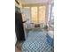 Screened porch with refrigerator, accent rug, and outdoor seating at 354 Blackburn Blvd, North Port, FL 34287