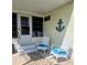 Inviting porch with comfortable rocking chairs, decorative anchor, and a welcoming entrance at 354 Blackburn Blvd, North Port, FL 34287