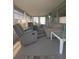 Inviting sunroom featuring comfortable seating, bright windows, and stylish decor at 354 Blackburn Blvd, North Port, FL 34287