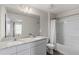 Bright bathroom with a double sink vanity featuring modern fixtures and a shower with tub at 401 Calendar St, Port Charlotte, FL 33954