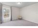 Bright bedroom with large window offering natural light and soft gray carpet at 401 Calendar St, Port Charlotte, FL 33954