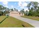 Front exterior of a cozy single-story house with a driveway and neatly trimmed lawn at 401 Calendar St, Port Charlotte, FL 33954