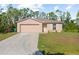 Charming single-story home with a well-maintained lawn and attached two-car garage at 401 Calendar St, Port Charlotte, FL 33954