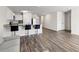 Bright open-concept kitchen and living area with wood-look floors and stainless appliances at 401 Calendar St, Port Charlotte, FL 33954
