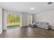 Spacious living area with ample natural light, wood-look flooring, and comfortable seating at 401 Calendar St, Port Charlotte, FL 33954