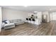 Open living space featuring wood-look floors, comfortable seating, and a view of the outdoors at 401 Calendar St, Port Charlotte, FL 33954