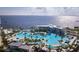 Breathtaking aerial view of resort's multiple pools, lush landscaping and serene waterfront setting at 4168 Harbor Blvd, Port Charlotte, FL 33952