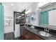 Modern bathroom with a double vanity, tiled floor, and a glass-enclosed shower at 4168 Harbor Blvd, Port Charlotte, FL 33952