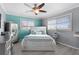 Bright bedroom featuring an inviting bed, a ceiling fan and soft, natural light at 4168 Harbor Blvd, Port Charlotte, FL 33952