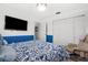 Bedroom featuring blue walls, closet, and a comfortable reading chair at 4168 Harbor Blvd, Port Charlotte, FL 33952