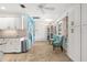 Dining area with white cabinets, tile flooring, natural light, and two teal chairs at 4168 Harbor Blvd, Port Charlotte, FL 33952