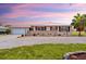 Charming home with a lush lawn, decorative flower boxes, and a circular driveway with ample parking at 4168 Harbor Blvd, Port Charlotte, FL 33952