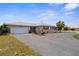 Attractive home featuring a paved driveway, a lush front yard, and tasteful stone accents along the facade at 4168 Harbor Blvd, Port Charlotte, FL 33952