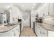Contemporary kitchen featuring white cabinets, stainless steel appliances, granite countertops, and tile flooring at 4168 Harbor Blvd, Port Charlotte, FL 33952