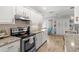 Modern kitchen featuring granite counters, stainless appliances, ample white cabinetry, and a functional design at 4168 Harbor Blvd, Port Charlotte, FL 33952