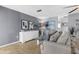 Cozy living room with tile flooring, neutral decor, and gray accent wall at 4168 Harbor Blvd, Port Charlotte, FL 33952