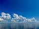 Beautiful, serene view of a calm ocean under a clear blue sky dotted with fluffy white clouds at 4168 Harbor Blvd, Port Charlotte, FL 33952
