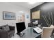 Well-lit office featuring black accent wall, modern desk, and tile flooring at 4168 Harbor Blvd, Port Charlotte, FL 33952