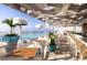 Stylish outdoor bar and lounge area overlooking a pool with beautiful water views at 4168 Harbor Blvd, Port Charlotte, FL 33952