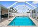 A sparkling screened-in pool with brick pavers offers a refreshing oasis for relaxation and recreation at 4168 Harbor Blvd, Port Charlotte, FL 33952