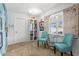 Bright sitting room featuring tile flooring, a window, and two teal chairs at 4168 Harbor Blvd, Port Charlotte, FL 33952