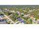 An aerial view showcases a neighborhood with various homes surrounded by mature trees and landscaping at 4331 Marcella Ter, North Port, FL 34286