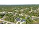Aerial view of homes nestled among trees, featuring lush lawns and some with screened-in pools at 4331 Marcella Ter, North Port, FL 34286
