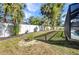 Manicured backyard featuring a white fence and tropical landscaping at 4331 Marcella Ter, North Port, FL 34286