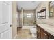 Bright bathroom featuring a tub shower, dark wooden vanity with a light countertop and decorative mirror at 4331 Marcella Ter, North Port, FL 34286