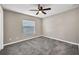 Neutral bedroom featuring a ceiling fan, carpet, and window at 4331 Marcella Ter, North Port, FL 34286