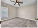 Neutral bedroom featuring a ceiling fan, carpet, and window at 4331 Marcella Ter, North Port, FL 34286