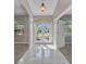 Bright foyer featuring tile flooring, an arched transom window above the front door, and neutral paint at 4331 Marcella Ter, North Port, FL 34286