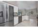 Bright kitchen featuring stainless steel appliances, granite countertops, white cabinets, and tile floors at 4331 Marcella Ter, North Port, FL 34286