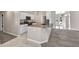 Kitchen island features granite countertops, white cabinets, and stainless steel appliances at 4331 Marcella Ter, North Port, FL 34286